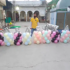 Here I am with the balloon pillars we created for a Khatu Shyam Ji event. We can create any name or message with these balloon letters.