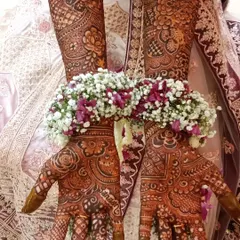 A beautiful shot of traditional mehendi paired with floral jewelry. This captures the complete and authentic wedding day look.