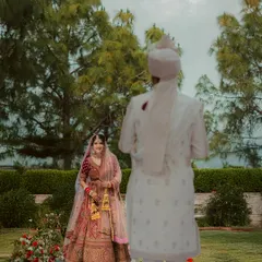 The first look. I capture the groom's back to the camera to build anticipation, focusing entirely on the bride's radiant smile as she sees him for the first time on the wedding day.