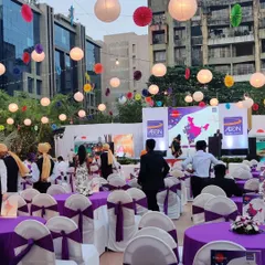 This was a large outdoor annual day for AON. I arranged the seating to provide clear sightlines to the stage for all attendees, using a mix of round tables and lounge-style sofas to cater to different guest preferences.
