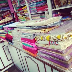 Stacks of colorful fabrics and materials ready to be turned into your custom outfits. I can help you select the right material for your design.