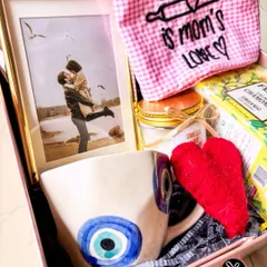 A close-up of the evil eye mug and personalized photo frame from the 'Get Well Soon' hamper, designed to be full of good wishes and love.