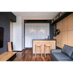 A completed residential lounge room featuring a custom-designed bar unit. This project shows how we integrate functional bar areas into home interiors, using materials like hardwood flooring and unique wall paneling to create a perfect vibe.