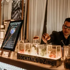 One of my mixologists preparing a tray of our signature smoky cocktails. Our team is trained in molecular techniques to deliver both exceptional taste and a memorable visual experience.