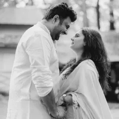 A beautiful black and white shot capturing a moment of shared laughter. The way they look at each other shows a deep connection and a friendship at the heart of their love.