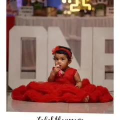 A precious moment from a first birthday photoshoot. I designed this fluffy red tulle frock and matching headband for the little princess.