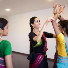 Personal correction is key to my teaching method. Here I am adjusting a student's arm and hand position to ensure she perfects the form, a practice central to the Guru-Shishya Parampara.