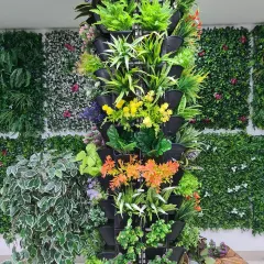 This freestanding vertical tower is filled with a variety of colorful artificial plants. It's a great, movable solution for adding a floral decoration to an office, lobby, or event space.