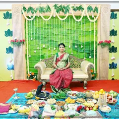 A mother-to-be seated for her Seemantham ceremony, with all the traditional offerings beautifully arranged before her. We handle the decor so you can focus on the blessings.