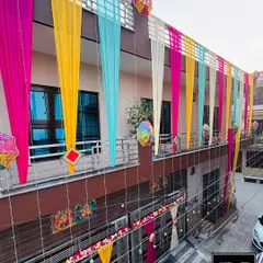 This is what we call the perfect 'Shadi Vala Ghar' feeling. We transformed the entire house front with vibrant, colorful drapes and traditional hangings, creating a festive and welcoming atmosphere for a wedding celebration.