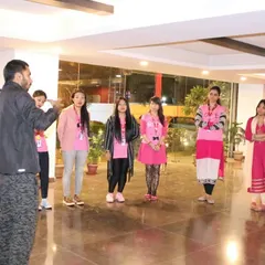 Addressing a group of female employees during a corporate self-defense workshop. The first step to safety is awareness and confidence.