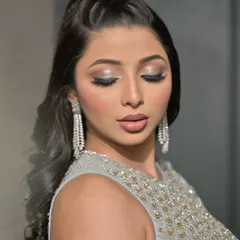 Another angle with eyes closed, highlighting the detailed eyeshadow work and the long, voluminous lashes.