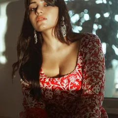 Capturing the golden hour glow on Symrann. The warm light enhances the rich red of her outfit and gives the portrait a dreamy quality.