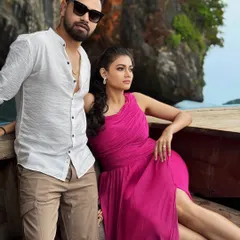 A stunning shot from a destination pre-wedding shoot in Thailand. The bride's vibrant dress and natural makeup look beautiful against the dramatic landscape.