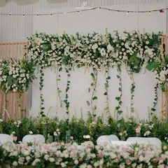 We crafted this breathtaking engagement stage using a lush arrangement of white florals and cascading ivy. The design combines natural textures with clean lines to create a backdrop that is both modern and timelessly elegant.