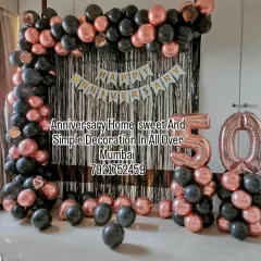 This 50th anniversary decoration shows a popular color combination of rose gold and black. We built a rectangular balloon arch over a shiny foil curtain, added a "Happy Anniversary" banner, and included large foil numbers to celebrate the golden anniversary in style. This setup is perfect for home parties.