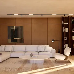 The informal living room at Kumo House features rich wood-paneled walls and a plush sectional sofa. It's a cozy, inviting space designed for relaxation and intimate family moments.