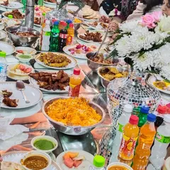 This is what barkat looks like. A table full of our food, with guests enjoying everything from Chicken Biryani to fried starters. We make sure there's more than enough for everyone to eat to their heart's content.
