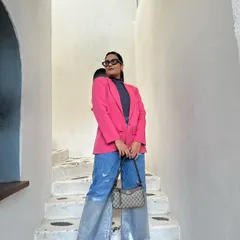 This is a personal style moment. I love playing with bold colors, like this pink blazer, and mixing high-end pieces with high-street finds. This kind of confident, vibrant style is a huge inspiration for my own designs.