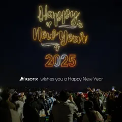 Ringing in the new year with a sky full of light. This show for New Year 2025 features a crowd watching as our drones write a festive message, creating a shared moment of hope and celebration.