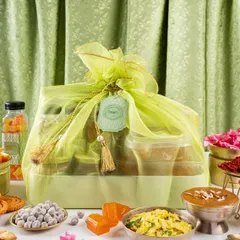 Wrapped with love, curated with care. This wedding hamper, packed in a beautiful lime-green organza potli, brings wholesome joy to your special day. It's light, thoughtful, and made for celebrations.