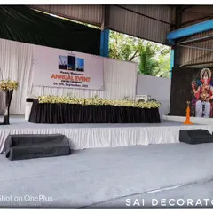 A clear view of the main stage for the Tara Chand annual function. The setup includes a formal dais for speakers, a podium, and simple, clean decorations suitable for a corporate awards ceremony.