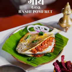 Capturing the essence of Goa with this Rashi Pomfret. The fish is simply presented on a banana leaf to let its vibrant red masala stuffing shine. The clean, rustic styling and regional typography celebrate the authentic flavors of Goan coastal cuisine.