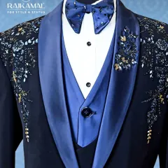 A close-up of my signature navy blue tuxedo, showing the embellished bow tie and the intricate floral beadwork on the satin lapel.