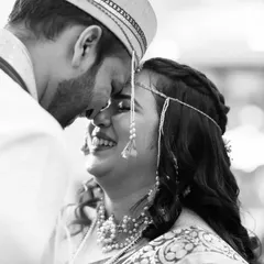 A beautiful black and white close-up capturing the bride's joyful tears as she shares an intimate moment with her groom.