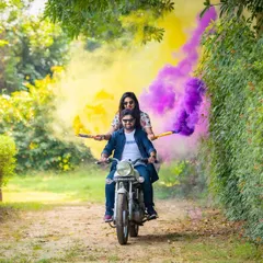 Let's have some fun with your pre-wedding shoot. This couple wanted something energetic and colorful, so we used smoke bombs while they rode a motorcycle through a green pathway. It’s a great way to show your playful side.