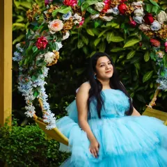 A moment of pure serenity. This stunning sky blue ruffle trail dress looks like it was made for this beautiful garden swing setting.