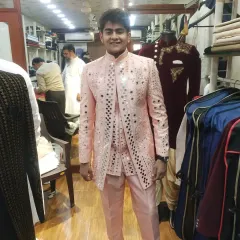 Our mirror work achkans are designed to make you shine. This light pink jacket is a festive and popular choice for grooms and groomsmen, reflecting light beautifully and ensuring you stand out at any celebration.