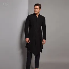 Bold in black. This asymmetrical longline kurta offers a modern, edgy take on traditional menswear, creating a powerful statement with its unique silhouette.