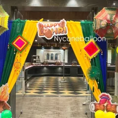 This is an entrance arch I created for a Lohri celebration. I used bright yellow, green, and blue drapes with traditional Punjabi hangings and umbrellas to welcome guests and set a festive mood right from the door.