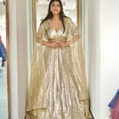 Gold glamour! A full shot of the gold sequin lehenga with a cape, an outfit that ensures you will shine brighter than the night.