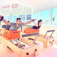 The Swan exercise performed in sync. This move strengthens the entire back of the body and requires deep core engagement from both partners to stay coordinated.