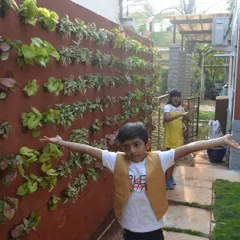 The joy on their faces says it all. A garden brings so much happiness, and a vertical garden like this one becomes an instant feature for the whole family to enjoy.