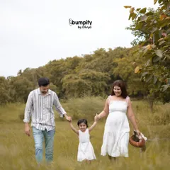 A happy family walk through a grassy field. Outdoor photoshoots are all about capturing movement, laughter, and the natural connection your family shares.