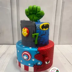 This two-tiered cake unites the greatest superheroes for a 7th birthday. We combined the worlds of Marvel and DC, featuring fondant details for Spider-Man, Captain America, Batman, and the Hulk's mighty fist.