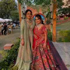 Posing together at a daytime wedding. Both clients are wearing looks I created, one more subtle and one more glam, showing the range of styles I offer.