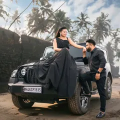 For a bold and modern pre-wedding look, our all-black coordinated outfits are a perfect choice. This long black gown pairs perfectly with a matching all-black men's outfit.