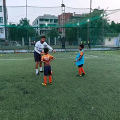 Nurturing the next generation of soccer stars. A coach gives specific instructions to two players during a training session.