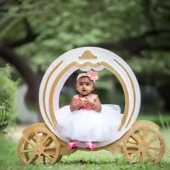 Every little girl deserves to feel like a princess. Our fairytale theme includes charming props like this carriage to create a magical setting for your toddler's portrait session.