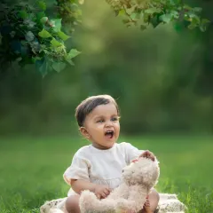 A baby makes a big, expressive yawn or shout while playing outdoors. Capturing these real, unscripted moments is what it's all about.