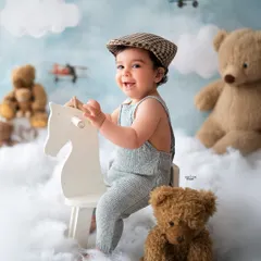 Giddy up! This little aviator is riding his rocking horse through the clouds, surrounded by his teddy bear friends. A perfect theme for an adventurous little boy.