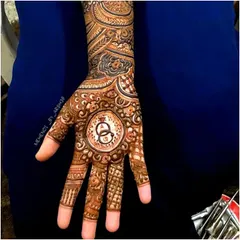 I love creating custom designs that tell your story. This engagement henna features the couple's initials, 'A' and 'Q', inside a central mandala with interlocking rings, symbolizing their union.