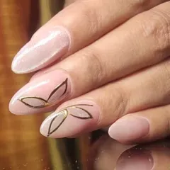 A minimalist and elegant design with a delicate gold leaf outline on a soft pink base.