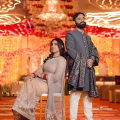 A stylish, posed portrait of the couple at their reception, exuding grace and elegance.