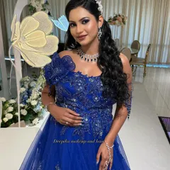 A beautiful client ready for her baby shower party in a stunning blue gown, with makeup that makes her glow.