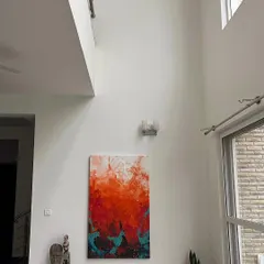 A large 5x3 feet abstract painting, "The Uprising," is perfectly complemented by the gallery's expansive wall space and natural light. We designed the venue to ensure every piece is seen at its best.